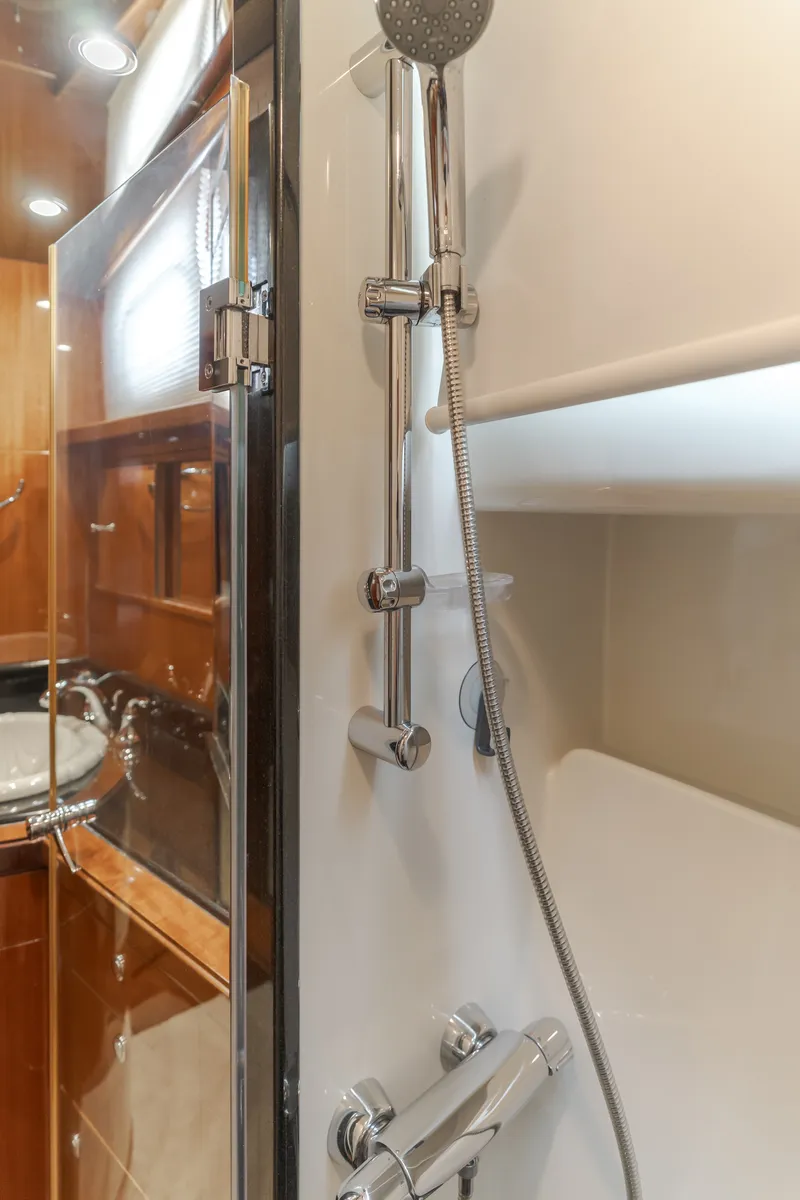 Slide: The Image of Bathroom with modern shower and wood paneling in a 2010 Ocean Alexander 68 Motor Yacht. - 46