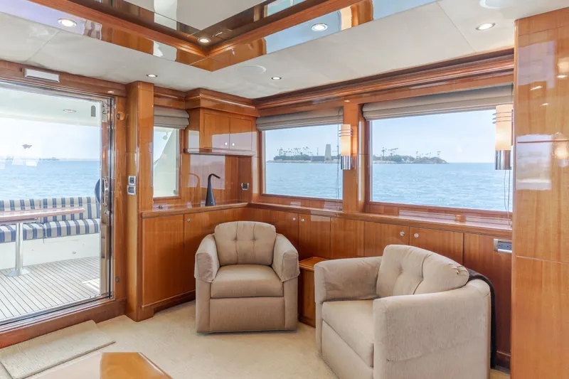 Slide: The Image of The interior of a 2010 Ocean Alexander 68 Motor Yacht features two comfortable chairs and large windows overlooking the sea. - 26