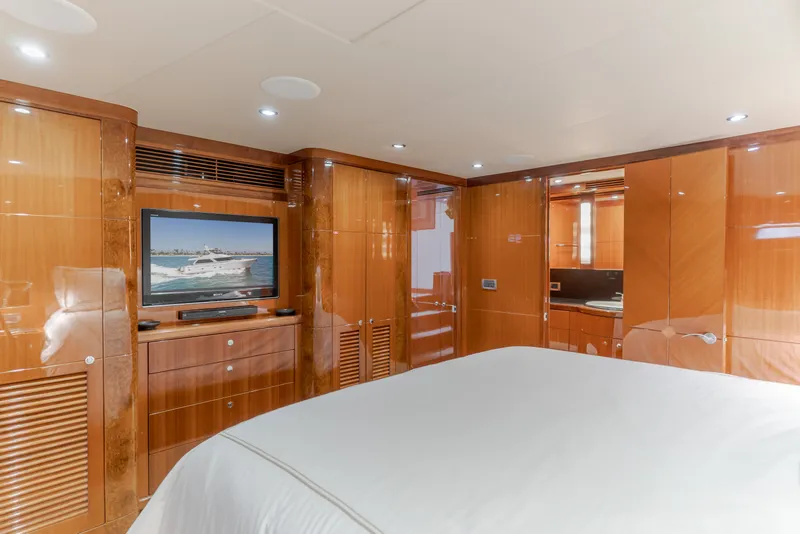 Slide: The Image of Luxurious cabin with glossy wood walls, a large bed, and a wall-mounted TV. - 38