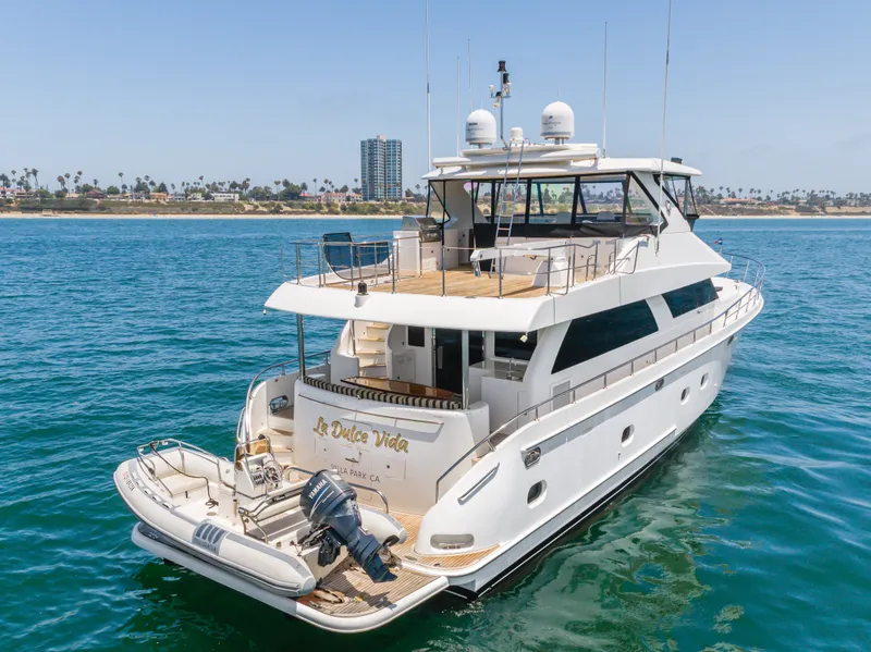 Slide: The Image of A luxurious white yacht with a tender, floating on calm waters near the coastline. - 6