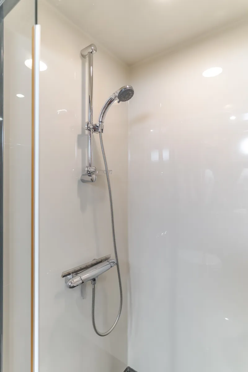 Slide: The Image of A modern shower stall with an adjustable showerhead and sleek fixtures. - 41