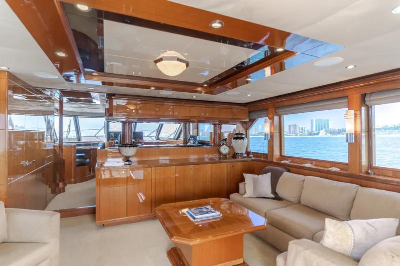 Slide: The Image of Luxurious salon of a 2010 Ocean Alexander 68 Motor Yacht with elegant wood accents and large windows. - 24