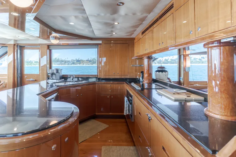 Slide: The Image of The luxurious kitchen of a 2010 Ocean Alexander 68 Motor Yacht with wood cabinets and granite countertops. - 31