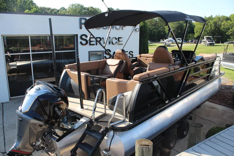 Slide: The Image of 2025 Veranda VTX 22RC pontoon boat with Yamaha engine, parked at dealership. - 4