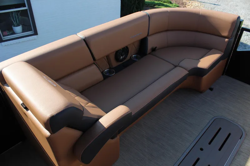 Slide: The Image of Luxurious seating on the 2025 Veranda VTX 22RC pontoon boat, featuring tan upholstery and cup holders. - 11