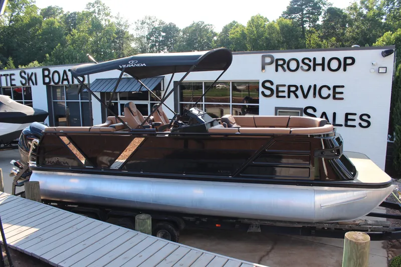 Slide: The Image of 2025 Veranda VTX 22RC pontoon boat displayed at a pro shop service and sales center. - 5