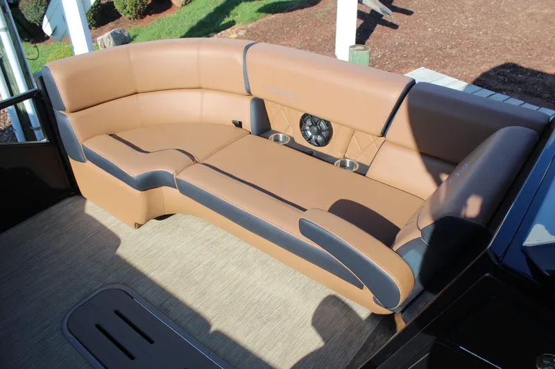 Slide: The Image of Luxurious tan seating on 2025 Veranda VTX 22RC boat, featuring integrated speakers and cup holders. - 12