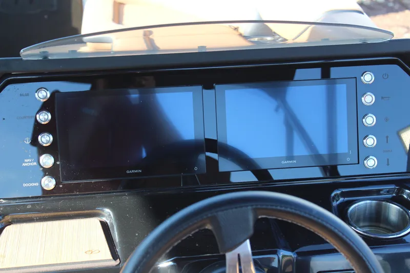 Slide: The Image of 2025 Veranda VTX 22RC dashboard featuring dual Garmin displays and control buttons. - 16