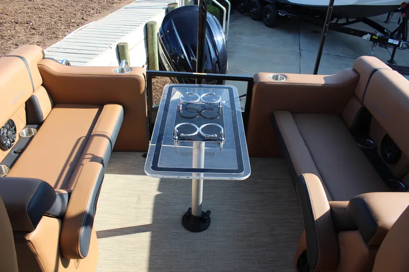 Slide: The Image of 2025 Veranda VTX 22RC boat interior with tan seating and a central table. - 9