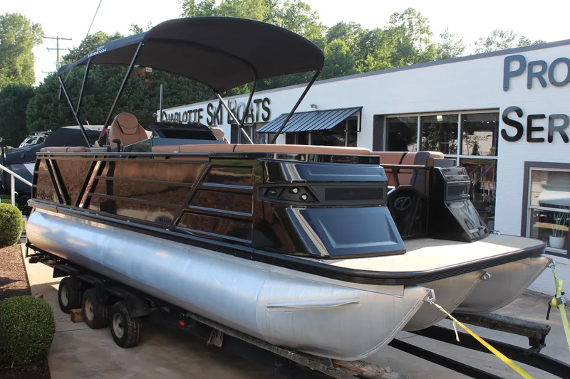 The Image of 2025 Veranda VTX 22RC pontoon boat displayed outdoors at a dealership. - 1