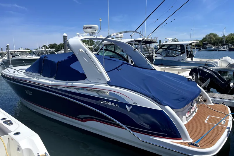 Slide: The Image of 2008 Formula 350 Sun Sport boat docked at marina, covered with blue tarp. - 3