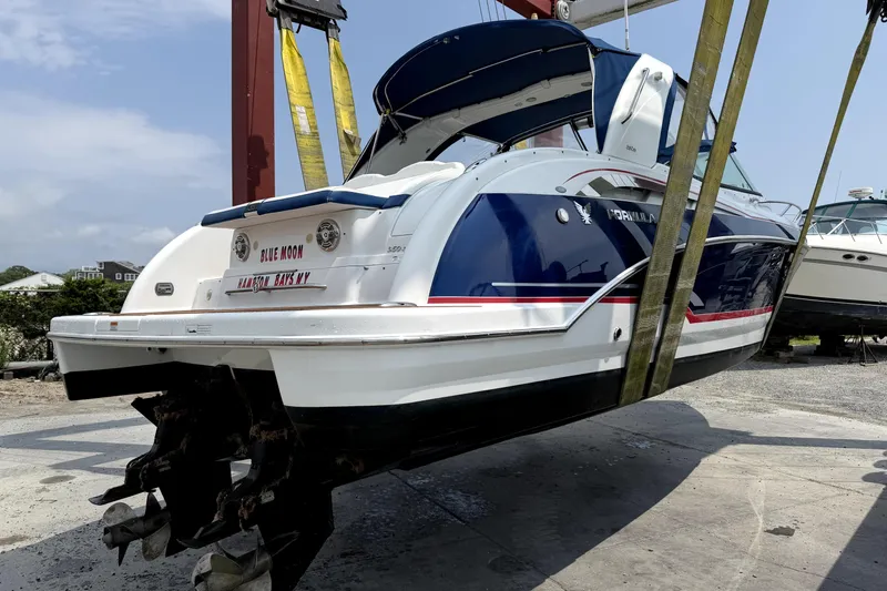 Slide: The Image of 2008 Formula 350 Sun Sport boat suspended by straps in a marina setting. - 15
