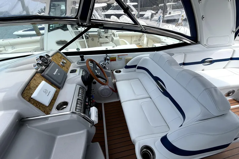 Slide: The Image of 2008 Formula 350 Sun Sport boat interior with white seating and wooden accents. - 9