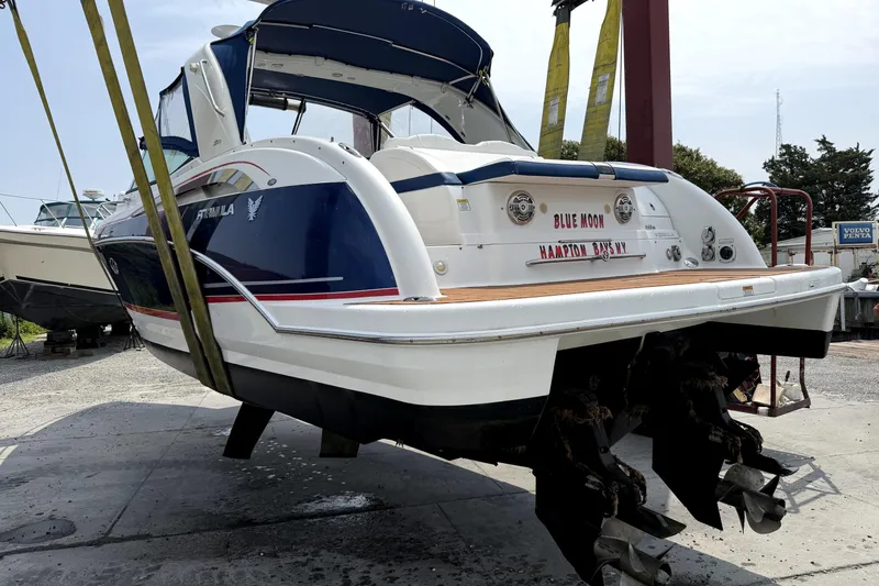 Slide: The Image of 2008 Formula 350 Sun Sport boat suspended for maintenance at a marina. - 16