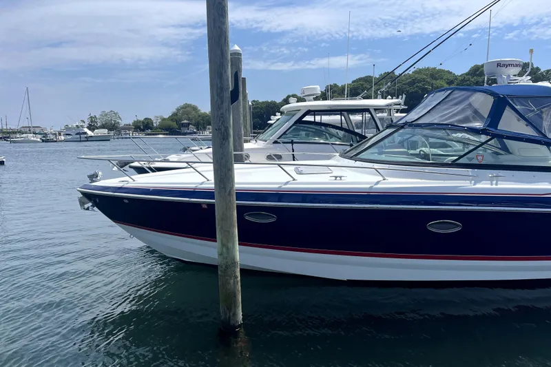 Slide: The Image of 2008 Formula 350 Sun Sport boat docked in a marina under a clear sky. - 5