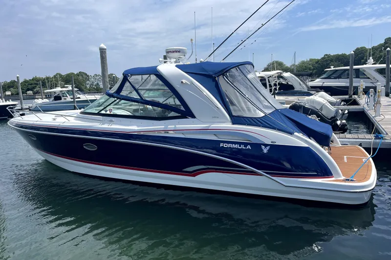 The Image of 2008 Formula 350 Sun Sport boat docked at marina, featuring sleek blue and white design. - 0
