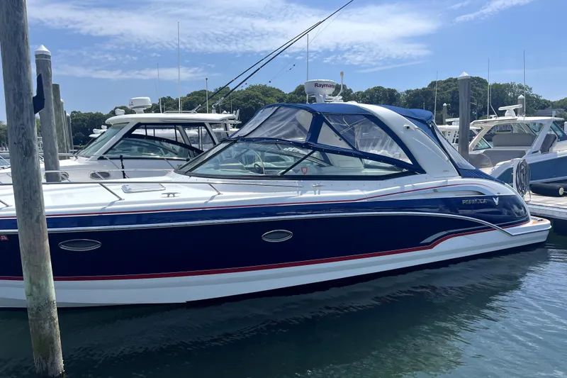 Slide: The Image of 2008 Formula 350 Sun Sport boat docked in marina, featuring sleek blue and white design. - 4