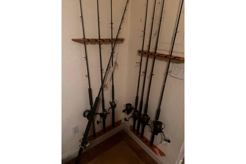 Slide: The Image of Corner fishing rod rack with multiple rods neatly organized. - 36