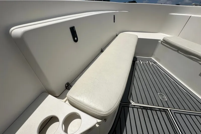 Slide: The Image of 2004 Pursuit 3070 Center Console boat interior with cushioned seating and cup holders. - 20