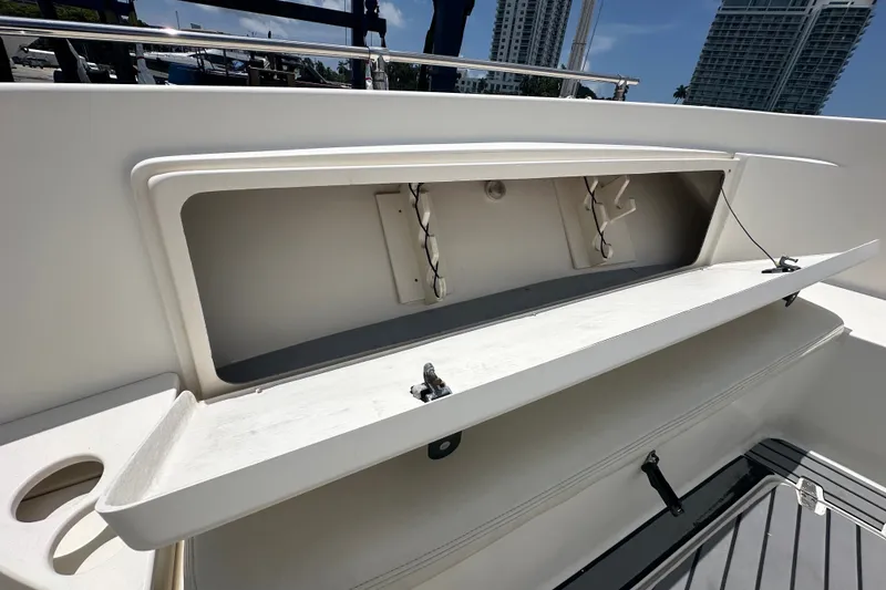 Slide: The Image of Open storage compartment on a 2004 Pursuit 3070 Center Console boat. - 21