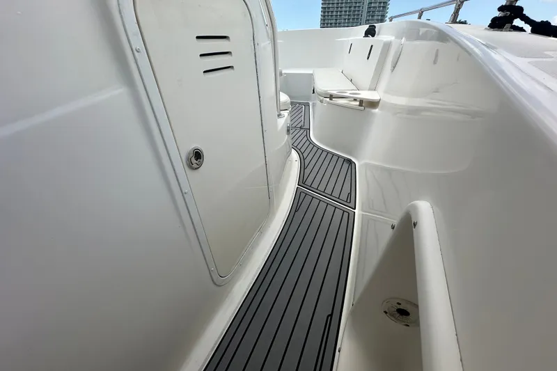 Slide: The Image of 2004 Pursuit 3070 Center Console boat interior with sleek seating and modern flooring. - 12