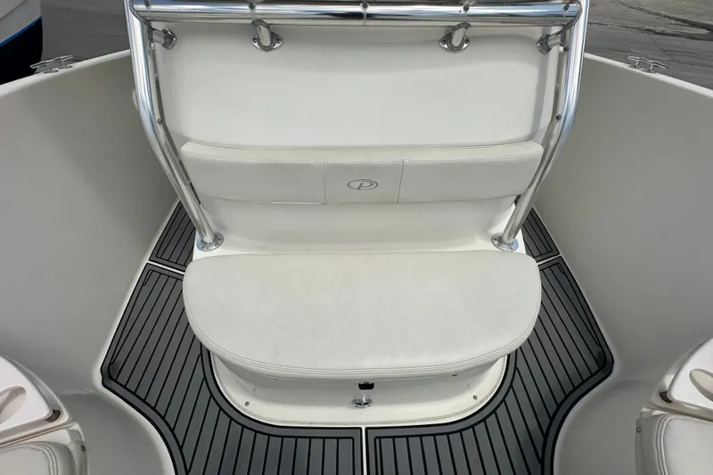 Slide: The Image of 2004 Pursuit 3070 Center Console boat seating with stainless steel railings and cushioned seat. - 24