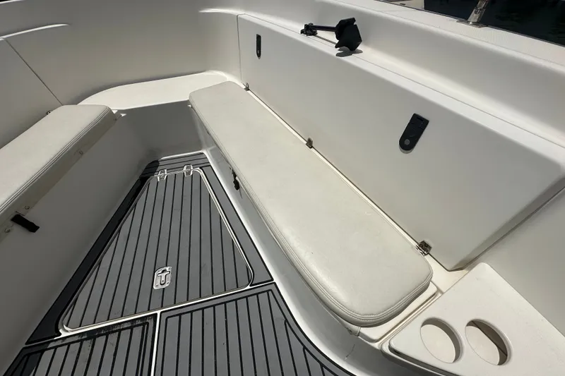 Slide: The Image of 2004 Pursuit 3070 Center Console boat interior with cushioned seating and non-slip flooring. - 16