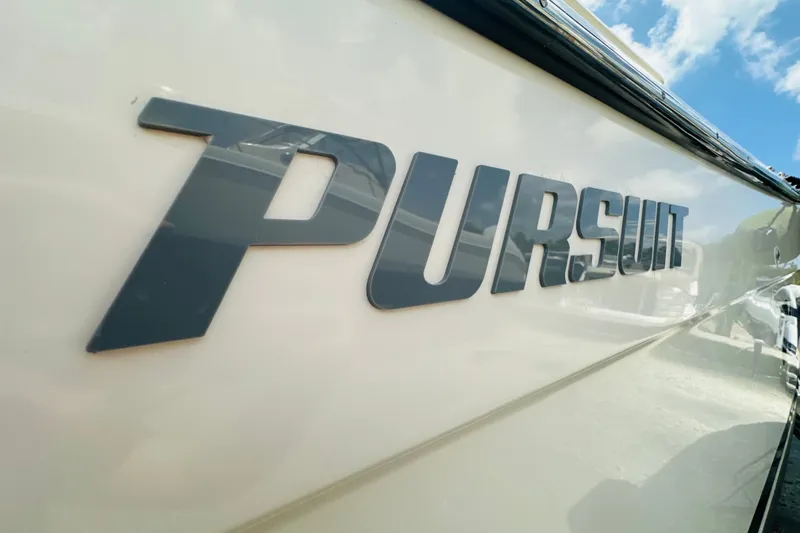 Slide: The Image of Close-up of "Pursuit" logo on 2004 Pursuit 3070 Center Console boat. - 28
