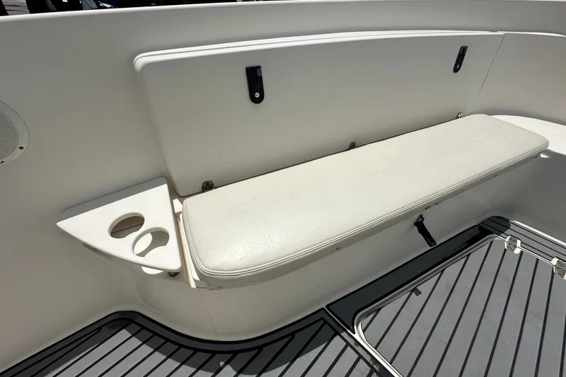 Slide: The Image of 2004 Pursuit 3070 Center Console boat seat with cup holders and storage compartment. - 23