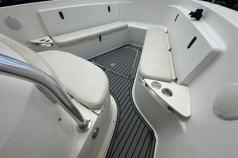 Slide: The Image of 2004 Pursuit 3070 Center Console boat interior with cushioned seating and cup holders. - 15