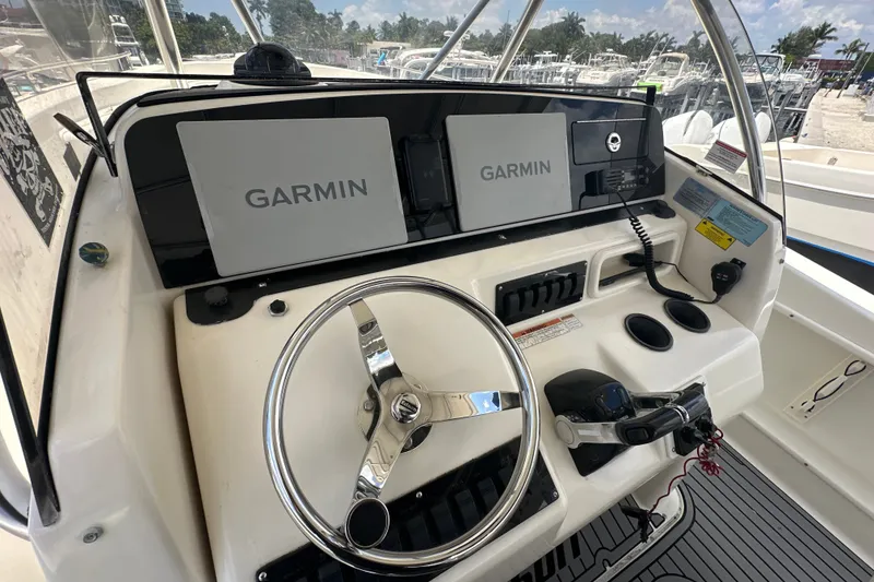 Slide: The Image of 2004 Pursuit 3070 Center Console boat dashboard with Garmin navigation systems. - 7