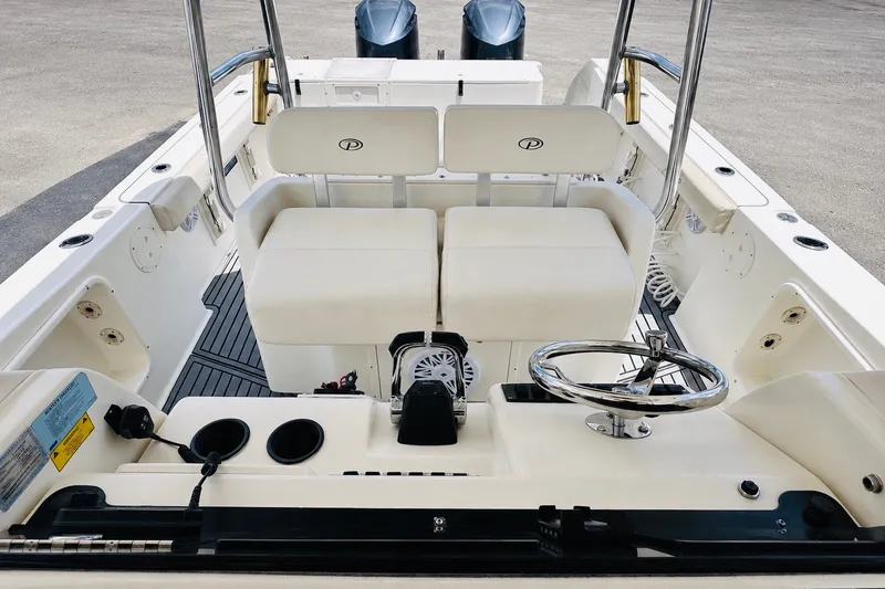 Slide: The Image of 2004 Pursuit 3070 Center Console boat interior with dual seating and steering wheel. - 27
