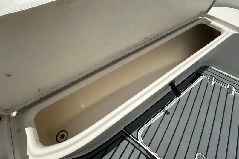 Slide: The Image of Open storage compartment on a 2004 Pursuit 3070 Center Console boat. - 22