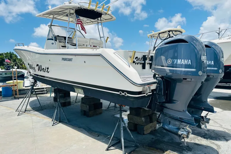 Slide: The Image of 2004 Pursuit 3070 Center Console boat with twin Yamaha engines on dry dock. - 1