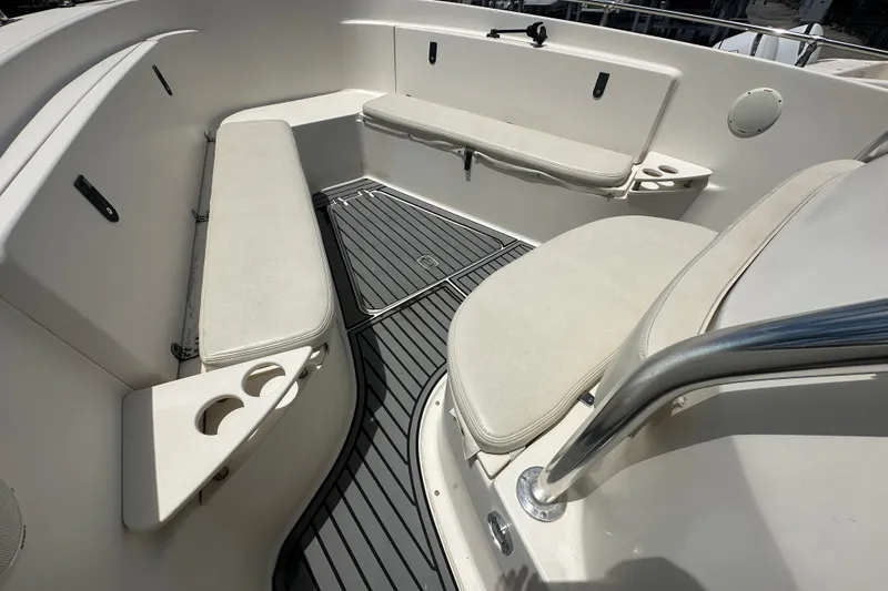 Slide: The Image of 2004 Pursuit 3070 Center Console boat interior with cushioned seating and cup holders. - 19