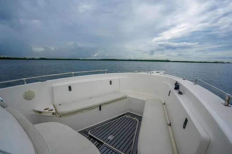 Slide: The Image of 2004 Pursuit 3070 Center Console boat on calm waters under cloudy sky. - 17