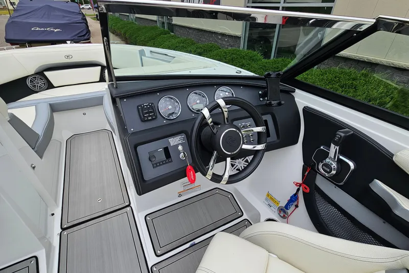 Slide: The Image of 2022 Cobalt CS23 boat interior with modern dashboard and steering wheel design. - 13