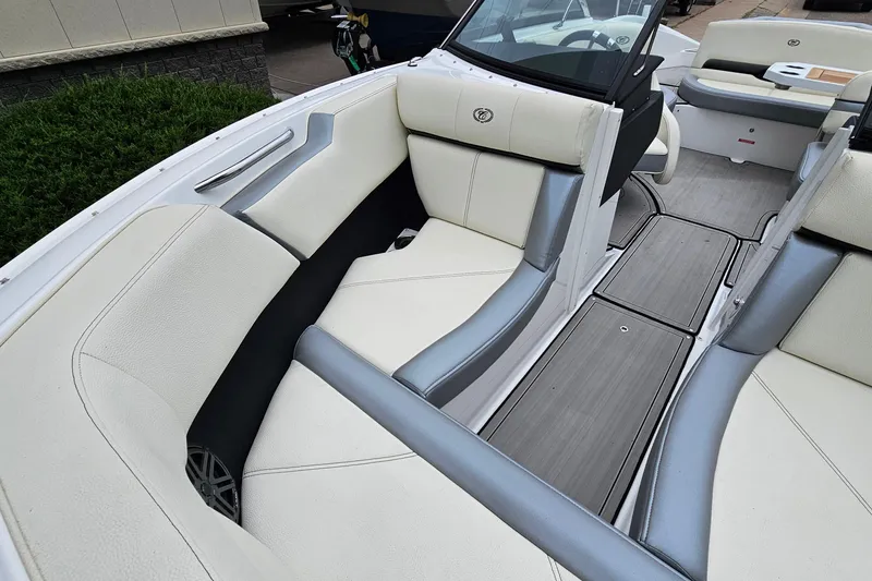 Slide: The Image of 2022 Cobalt CS23 boat interior with white and gray seating, sleek design. - 19