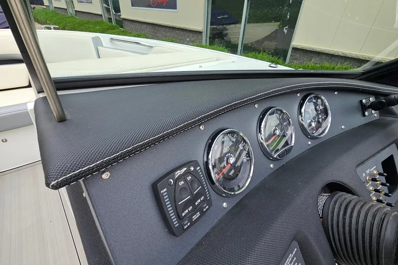 Slide: The Image of Dashboard of a 2022 Cobalt CS23 boat with gauges and controls. - 14