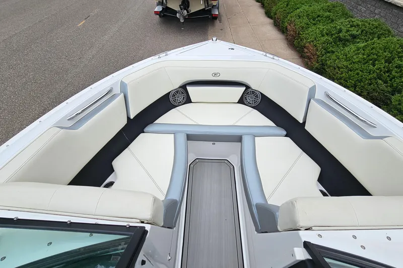 Slide: The Image of 2022 Cobalt CS23 boat interior with white seating and modern design. - 16