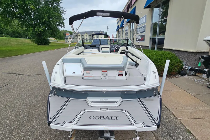 Slide: The Image of 2022 Cobalt CS23 boat with sleek design, parked outside a dealership. - 5