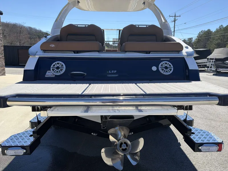 Slide: The Image of The image shows the rear of a 2026 Regal LS9 boat with a swim platform and propeller. - 9