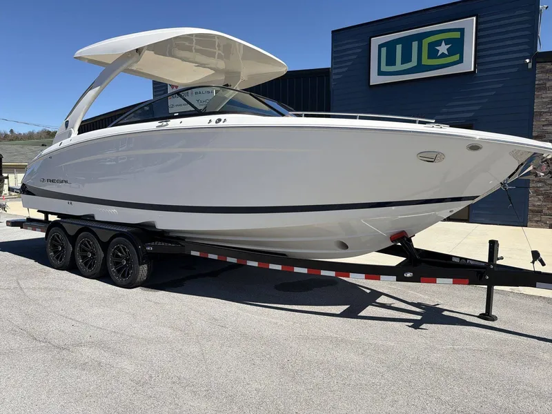 Slide: The Image of A white 2026 Regal LS9 boat on a trailer in front of a building. - 27