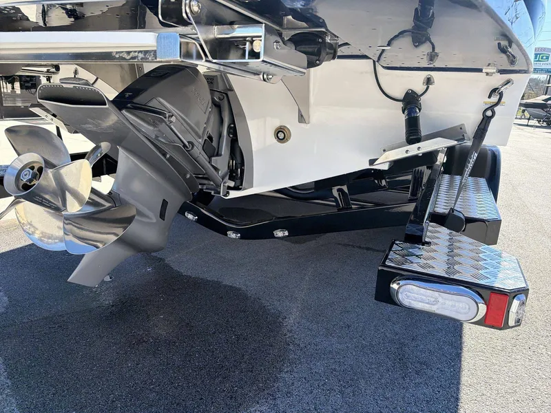 Slide: The Image of The image shows the stern of a 2026 Regal LS9 boat with a propeller and trailer. - 23