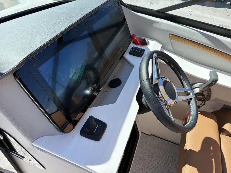 Slide: The Image of The image shows the cockpit of a Regal LS9 boat with a modern helm and large display. - 6