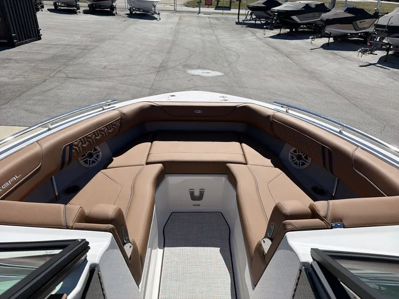 Slide: The Image of The image shows the bow of a Regal LS9 boat with brown upholstery and speakers. - 21