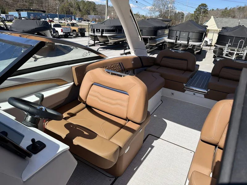 Slide: The Image of The image shows the interior of a 2026 Regal LS9 boat with sleek brown leather seating. - 22