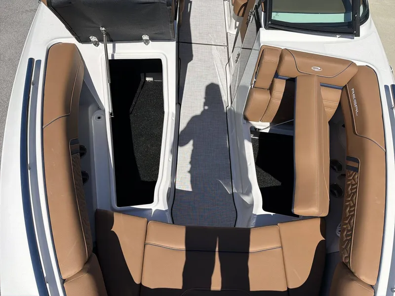 Slide: The Image of The image shows the cockpit of a Regal LS9 boat with brown seating and storage compartments. - 30