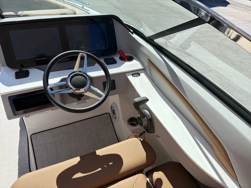 Slide: The Image of The image shows the cockpit of a Regal LS9 boat with a modern steering wheel and large display. - 16