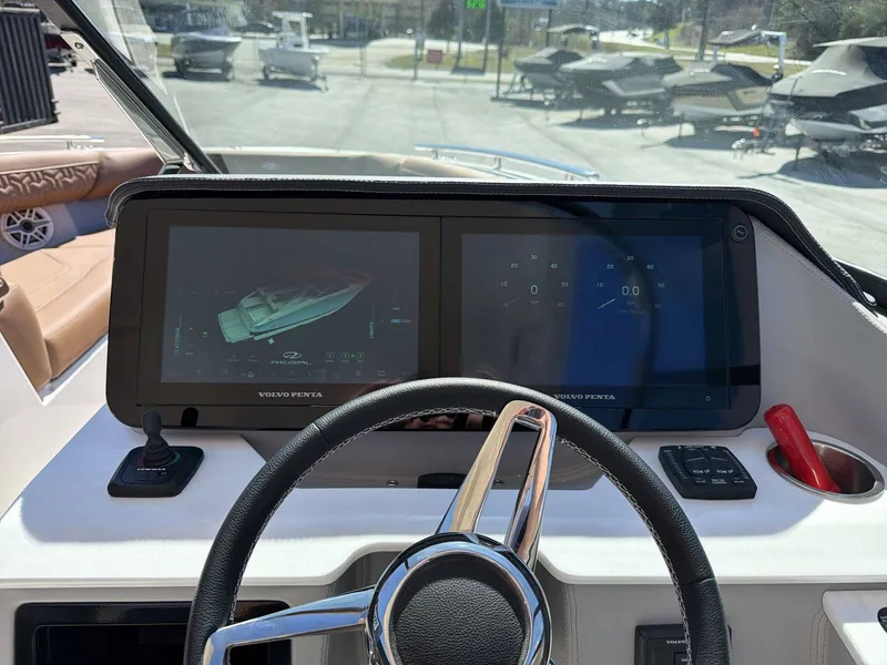 Slide: The Image of The image shows the cockpit of a Regal LS9 boat with modern digital displays and a steering wheel. - 10